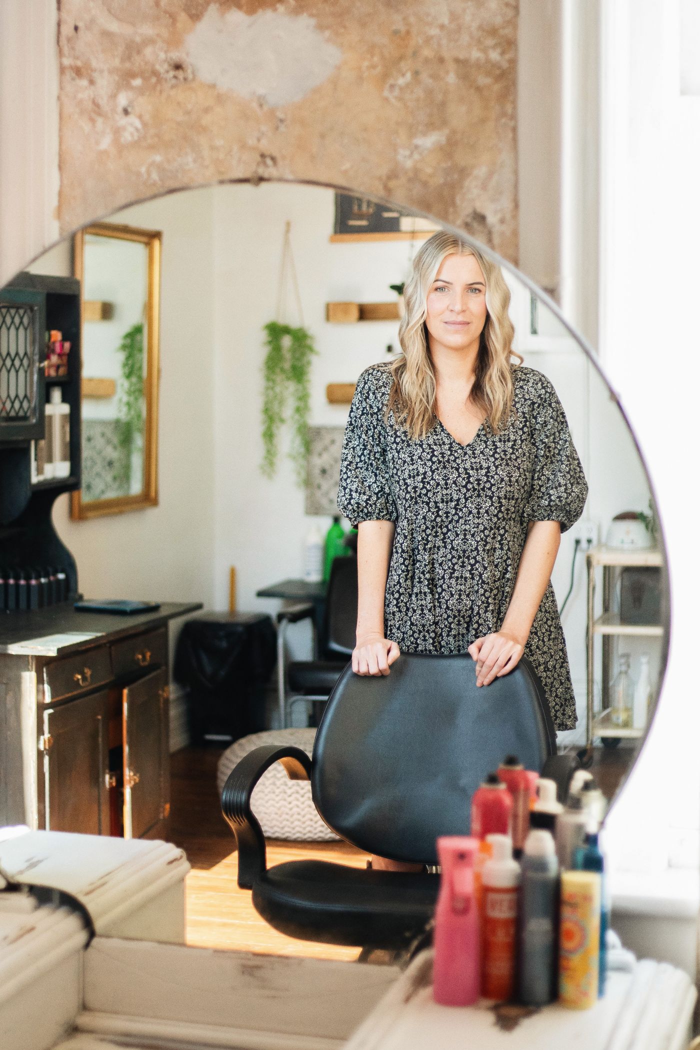 Salon owner standing confidently in her salon